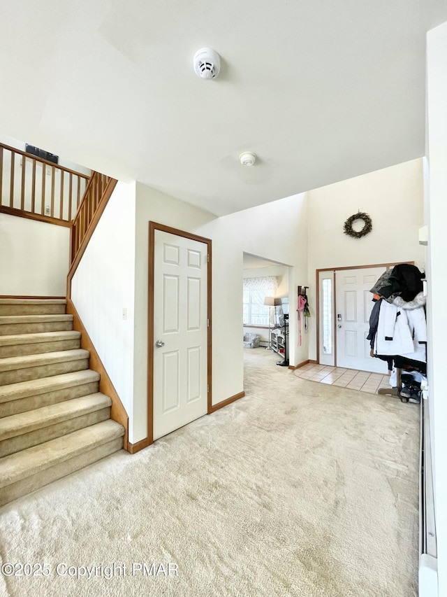 foyer entrance with light carpet