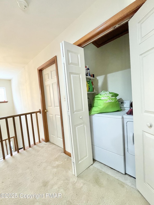 laundry area featuring light carpet and independent washer and dryer