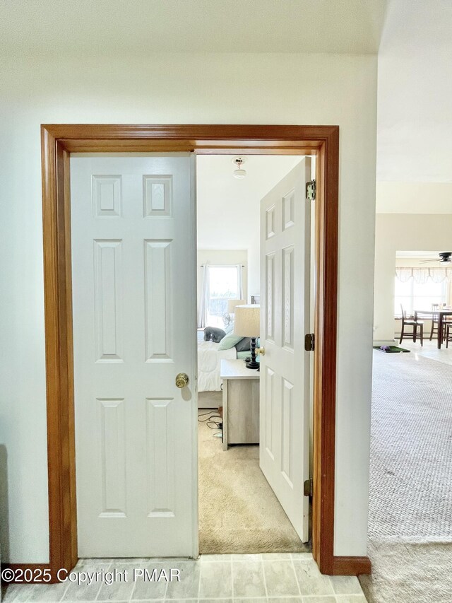 hallway featuring light carpet