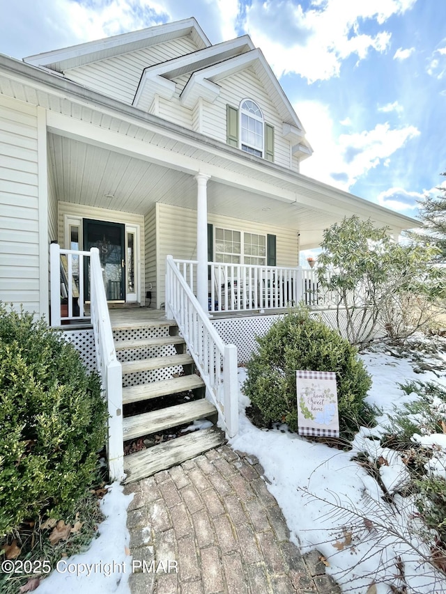 view of snow covered property entrance