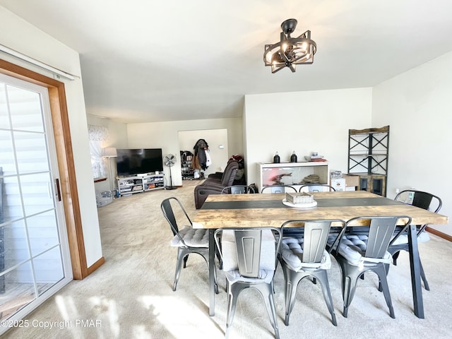 dining area featuring light carpet