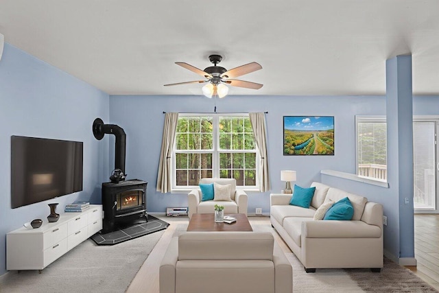 2615 Vista Dr, Blakeslee, PA 18610 - living area featuring a wood stove, a ceiling fan, and carpet flooring