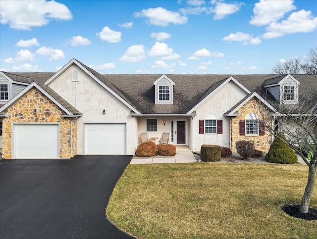 view of front facade featuring stucco siding, an attached garage, a front yard, stone siding, and driveway