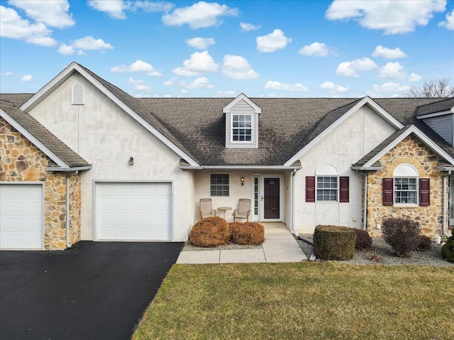 view of front of house with an attached garage, driveway, stone siding, stucco siding, and a front yard