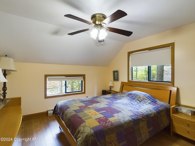 bedroom with lofted ceiling, multiple windows, a ceiling fan, and hardwood / wood-style floors