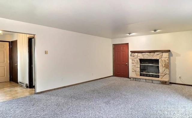 1019 Jackson View Rd, Stroudsburg, PA 18360 - unfurnished living room featuring carpet, baseboards, a stone fireplace, and a baseboard heating unit