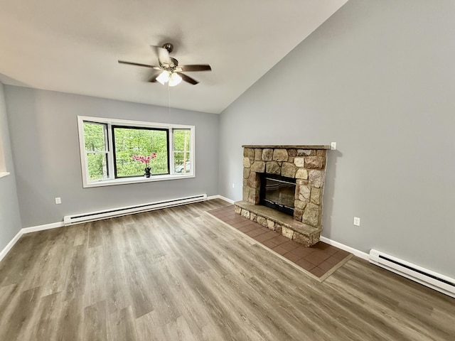 1223 Coolbaugh Rd, East Stroudsburg, PA 18302 - unfurnished living room with a baseboard radiator, ceiling fan, a stone fireplace, wood finished floors, and lofted ceiling