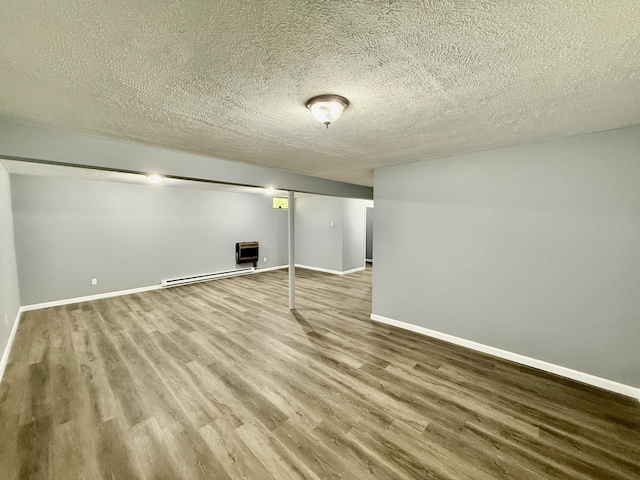 1223 Coolbaugh Rd, East Stroudsburg, PA 18302 - finished basement featuring wood finished floors, a textured ceiling, baseboards, and baseboard heating