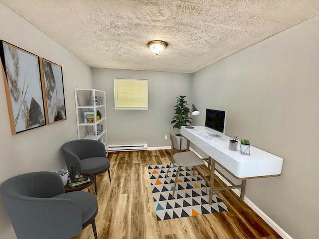 1223 Coolbaugh Rd, East Stroudsburg, PA 18302 - office area featuring a baseboard radiator, wood finished floors, baseboards, and a textured ceiling