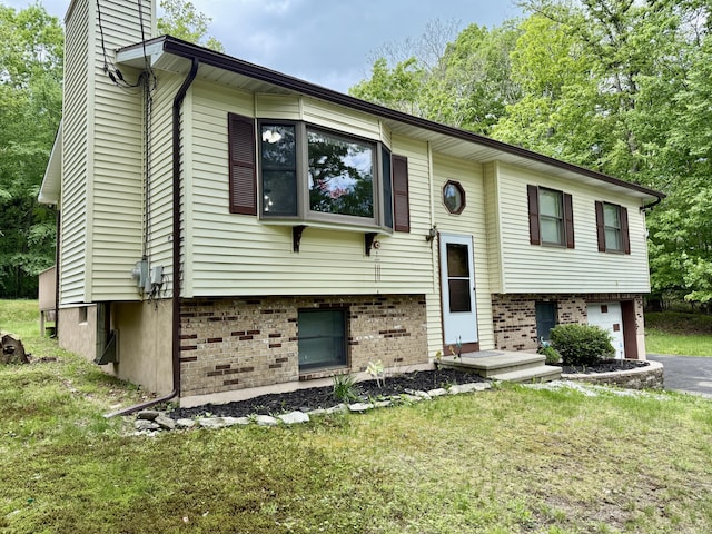 1223 Coolbaugh Rd, East Stroudsburg, PA 18302 - bi-level home featuring a garage, a chimney, asphalt driveway, and a front yard