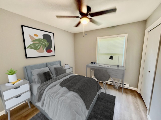 1223 Coolbaugh Rd, East Stroudsburg, PA 18302 - bedroom with wood finished floors, baseboard heating, a ceiling fan, and a closet