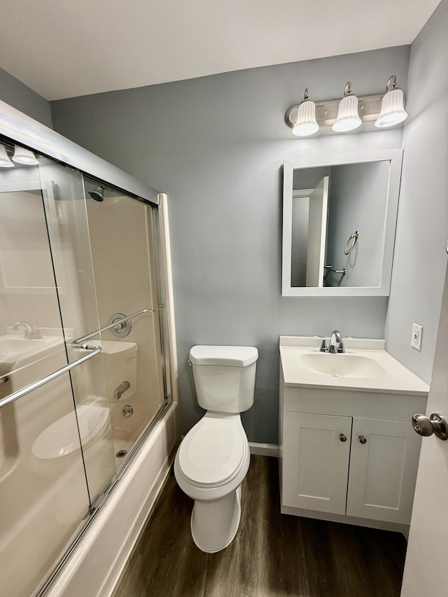 1223 Coolbaugh Rd, East Stroudsburg, PA 18302 - full bathroom featuring wood finished floors, toilet, shower / bath combination with glass door, vanity, and baseboards