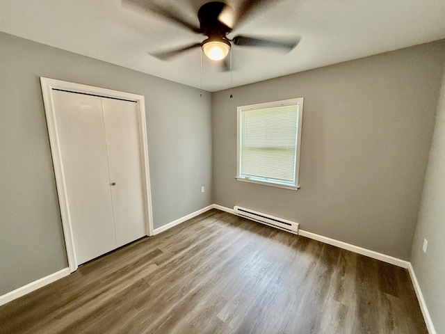 1223 Coolbaugh Rd, East Stroudsburg, PA 18302 - unfurnished bedroom featuring a baseboard radiator, wood finished floors, baseboards, a closet, and a ceiling fan
