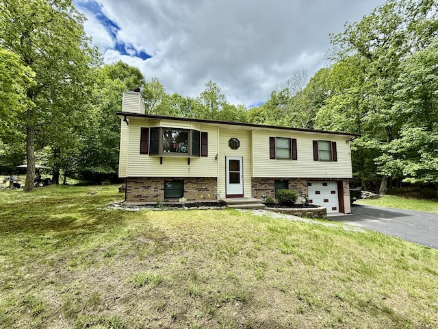 1223 Coolbaugh Rd, East Stroudsburg, PA 18302 - bi-level home with driveway, a garage, a chimney, and a front lawn