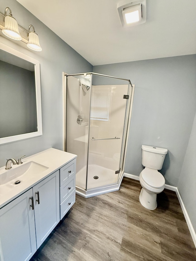 1223 Coolbaugh Rd, East Stroudsburg, PA 18302 - bathroom featuring a stall shower, wood finished floors, baseboards, and toilet