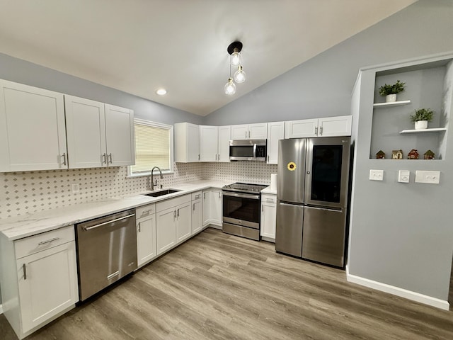 1223 Coolbaugh Rd, East Stroudsburg, PA 18302 - kitchen with stainless steel appliances, a sink, decorative backsplash, vaulted ceiling, and light wood finished floors