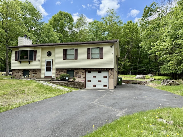 1223 Coolbaugh Rd, East Stroudsburg, PA 18302 - split foyer home featuring a chimney, driveway, brick siding, and a garage