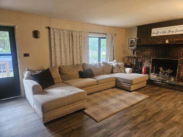 159 Summit Ave, Pocono Summit, PA 18346 - living room featuring wood finished floors, a brick fireplace, and wood walls