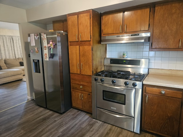 159 Summit Ave, Pocono Summit, PA 18346 - kitchen with appliances with stainless steel finishes, under cabinet range hood, dark wood-style flooring, tasteful backsplash, and light countertops