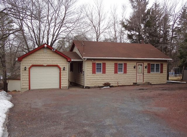 single story home featuring an attached garage and driveway