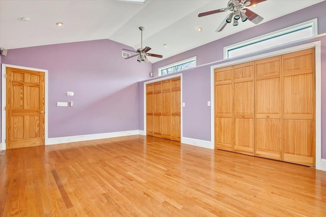 unfurnished bedroom featuring light wood-style floors, vaulted ceiling, ceiling fan, baseboards, and visible vents