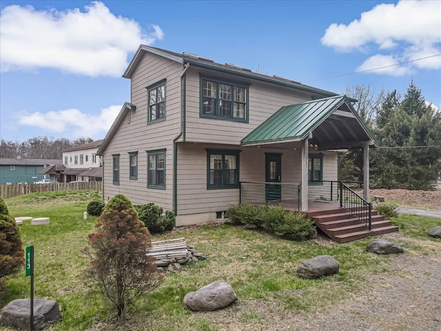 view of front of property with fence, a front yard, and a porch