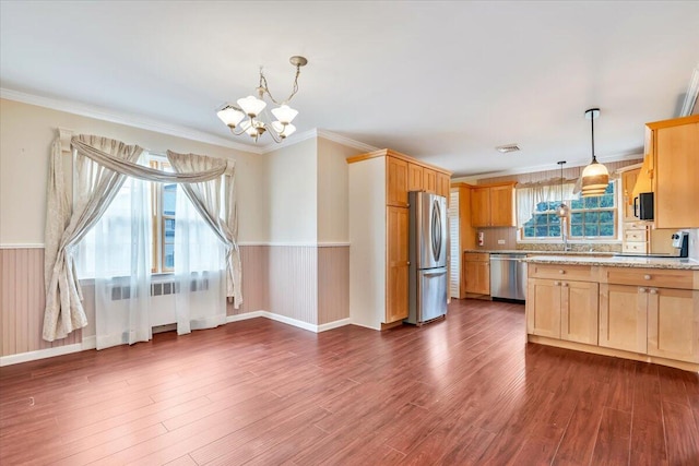 kitchen with an inviting chandelier, appliances with stainless steel finishes, radiator heating unit, dark wood-style floors, and pendant lighting