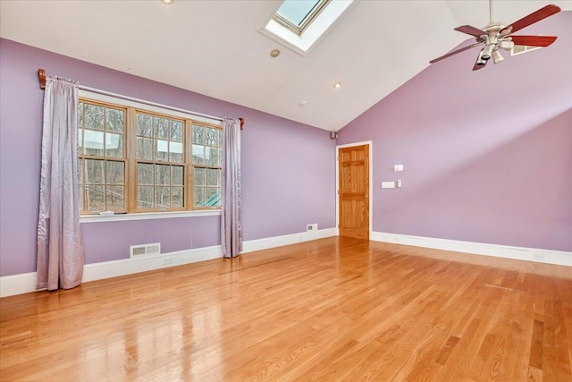 unfurnished room with wood finished floors, visible vents, baseboards, and a skylight