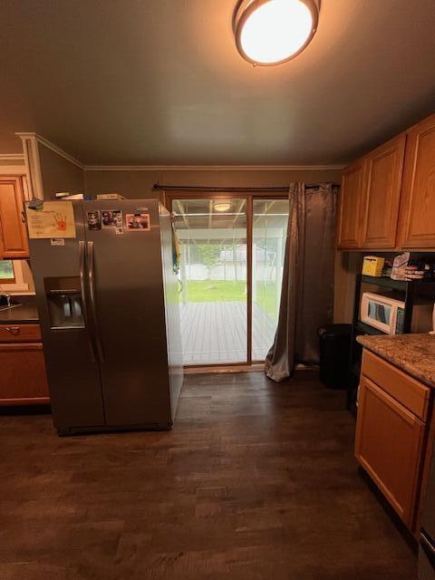 501 Lake Spangenberg Rd, Jefferson Township, PA 18436 - kitchen with stainless steel fridge with ice dispenser, white microwave, dark wood-type flooring, ornamental molding, and brown cabinetry