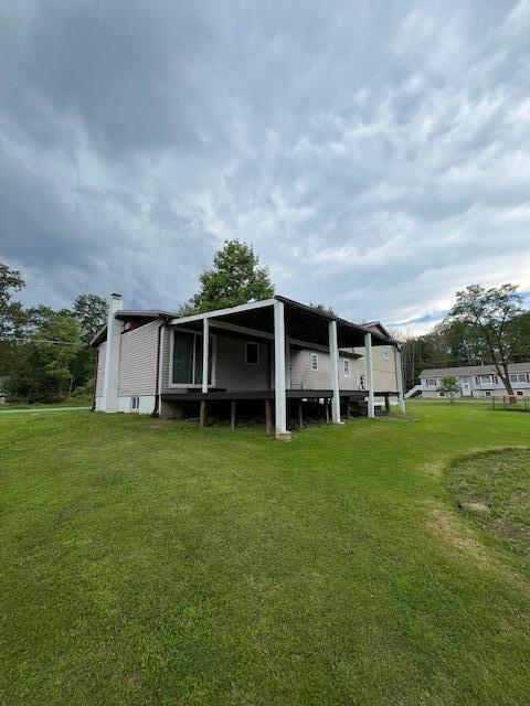 501 Lake Spangenberg Rd, Jefferson Township, PA 18436 - rear view of house with a lawn