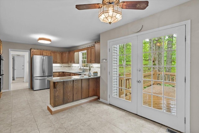 127 Ladderback Ln, Cresco, PA 18326 - kitchen featuring freestanding refrigerator, a sink, a peninsula, french doors, and ceiling fan