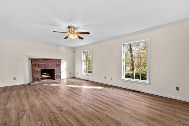 127 Ladderback Ln, Cresco, PA 18326 - unfurnished living room with a ceiling fan, baseboards, wood finished floors, crown molding, and a brick fireplace