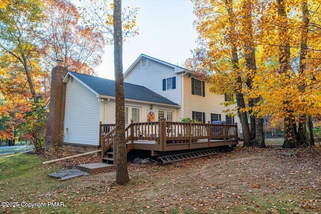 back of house with french doors, a deck, and a chimney