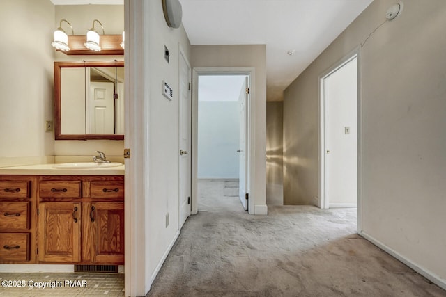 127 Ladderback Ln, Cresco, PA 18326 - hall featuring a sink, light colored carpet, and baseboards