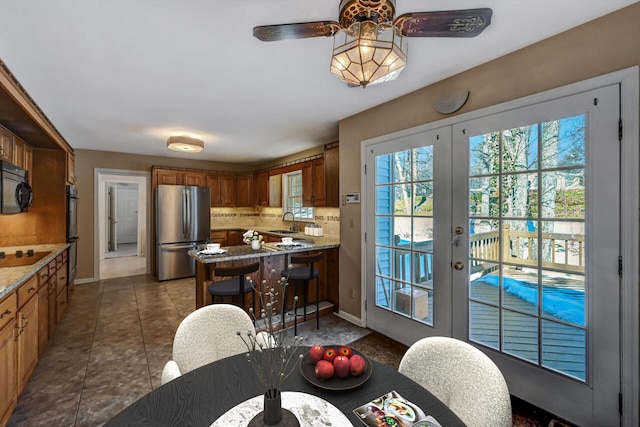 dining area with baseboards, ceiling fan, french doors, and tile patterned flooring