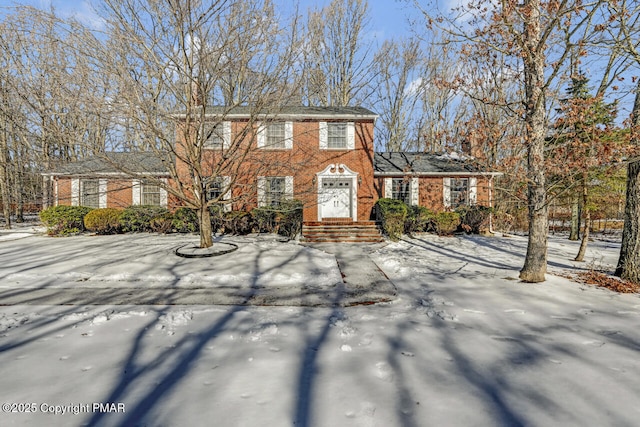 colonial home with brick siding