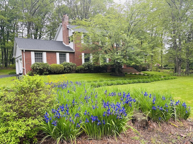 127 Ladderback Ln, Cresco, PA 18326 - view of front of home with a chimney, brick siding, a garage, and a front yard