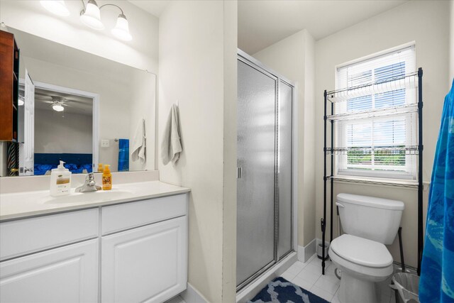 full bath with vanity, tile patterned floors, a shower stall, and toilet