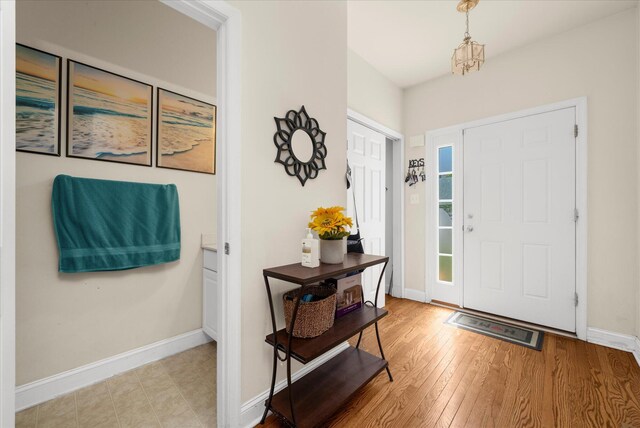 entrance foyer featuring baseboards and wood finished floors