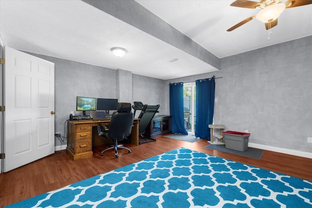 office space with a ceiling fan, baseboards, and wood finished floors
