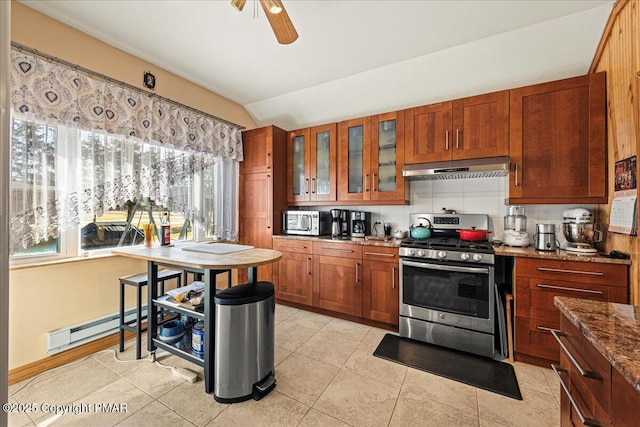 kitchen with extractor fan, stone countertops, lofted ceiling, baseboard heating, and stainless steel appliances