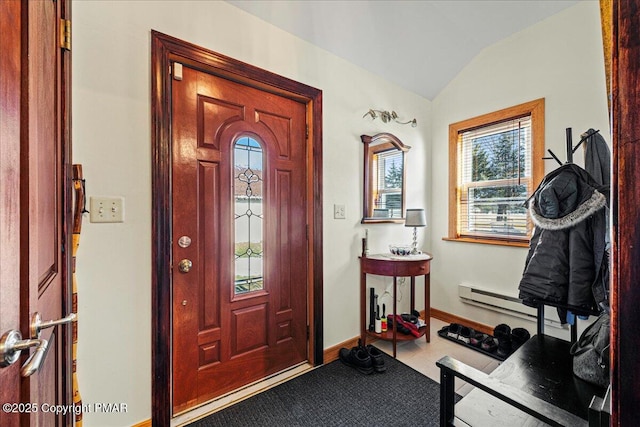 entryway with a baseboard radiator, baseboards, and vaulted ceiling