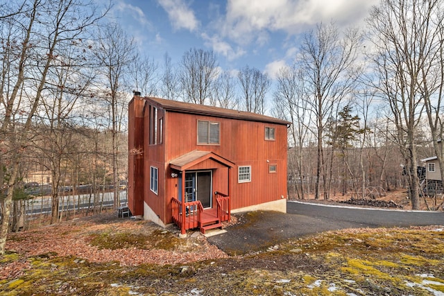 view of front of home featuring fence and a chimney