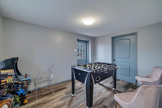 game room featuring baseboards and wood finished floors