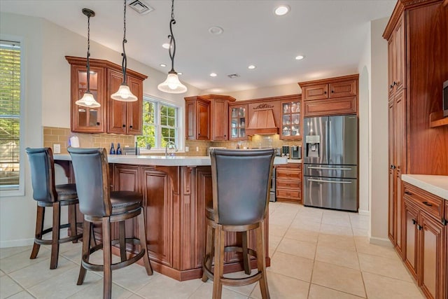 175 Wyndham Dr, Cresco, PA 18326 - kitchen featuring stainless steel refrigerator with ice dispenser, a peninsula, brown cabinets, tasteful backsplash, and recessed lighting