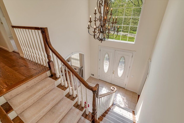 175 Wyndham Dr, Cresco, PA 18326 - tiled foyer entrance with a chandelier, a high ceiling, arched walkways, stairway, and baseboards
