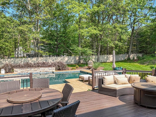 175 Wyndham Dr, Cresco, PA 18326 - wooden deck featuring a fenced backyard, outdoor dining space, view of scattered trees, and an outdoor living space with a fire pit