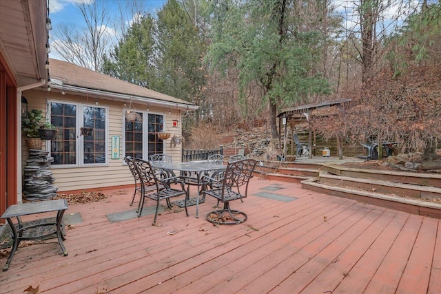 wooden terrace featuring outdoor dining area