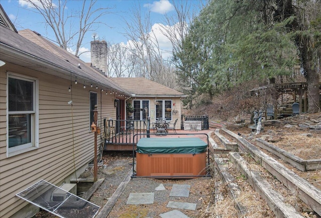 exterior space featuring a hot tub and a deck