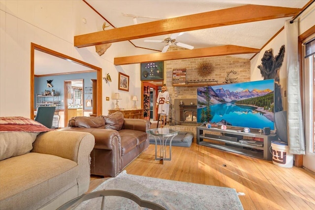 living area with beamed ceiling, wood-type flooring, high vaulted ceiling, and crown molding